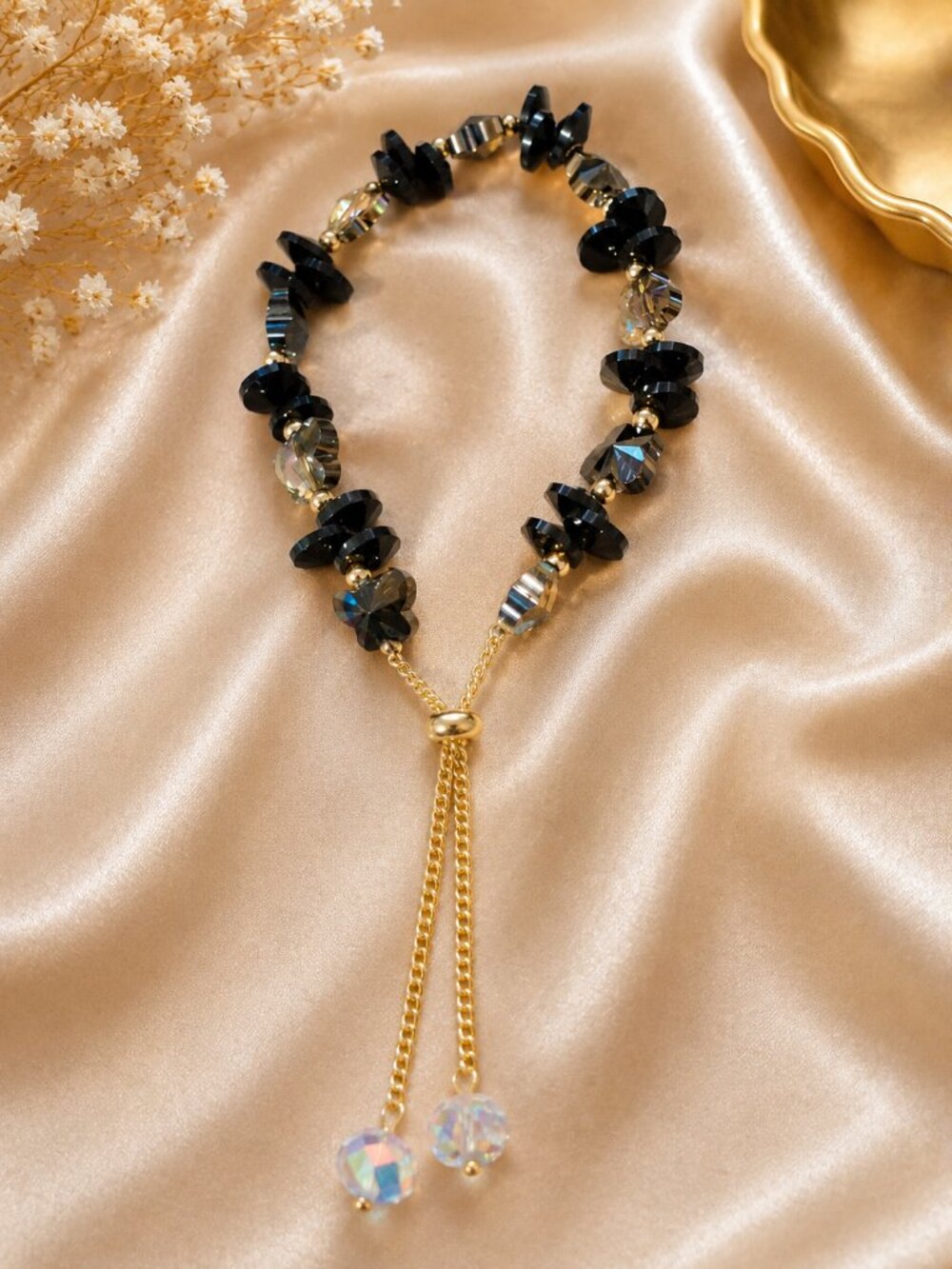 Elegant adjustable bracelet features a beautiful mix of deep black and smoky-bla